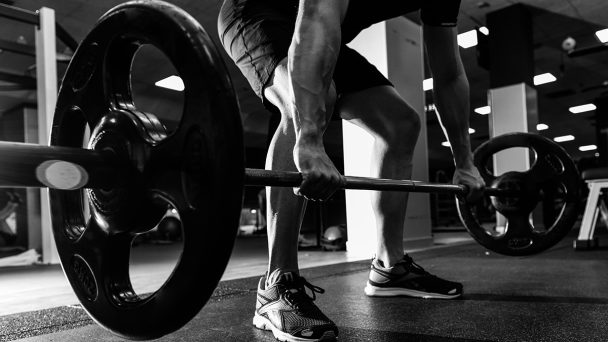 close-up-of-young-muscular-man-lifting-weights-at-SLAPXEM-1.jpg